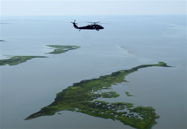 Louisiana Gov. Bobby Jindal flies over small islands in Baritaria Bay to check on the effort to protect the marsh from oil from the Deepwater Horizon oil spill Friday.